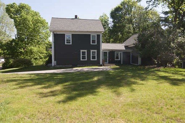 4 Shaw Street Medway, MA 02053 - Photo 21 of 25 a front view of a house with a yard table and chairs