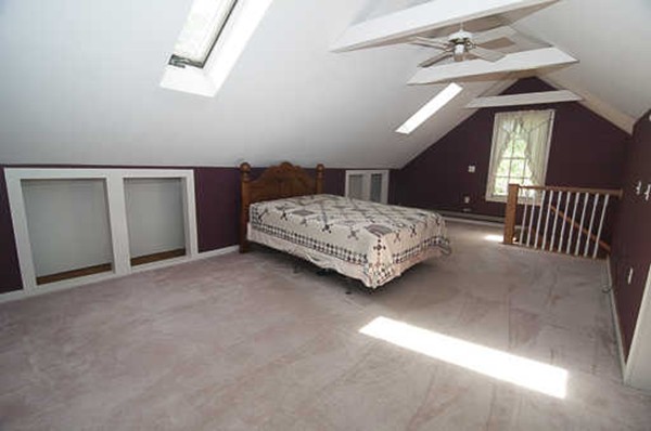 4 Shaw Street Medway, MA 02053 - Photo 5 of 25 a spacious bedroom with a bed and a chandelier