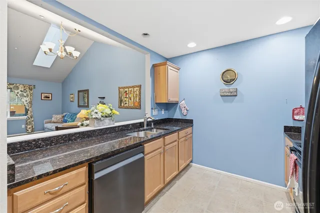 a bathroom with a granite countertop sink a toilet and a mirror