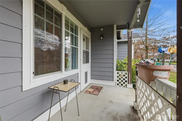 a backyard of a house with barbeque oven table and chairs