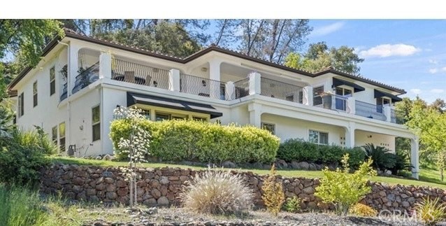 3217 Shallow Springs Terrace Chico, CA 95928 - Photo 1 of 55 a view of a white house with a yard and plants