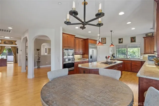 a view of a dining room with furniture and chandelier