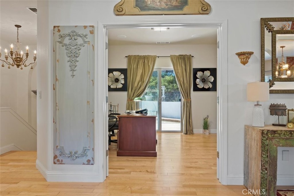 3217 Shallow Springs Terrace Chico, CA 95928 - Photo 30 of 55 a view of a hallway with wooden floor and a living room