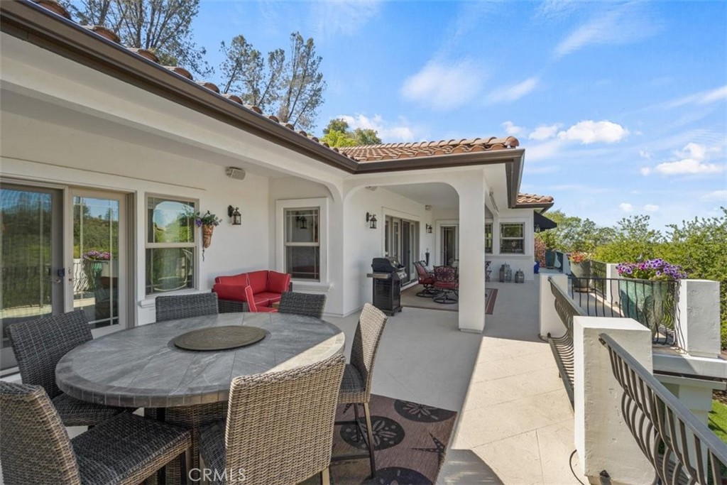 3217 Shallow Springs Terrace Chico, CA 95928 - Photo 3 of 55 a view of a patio with table and chairs with wooden floor and fence
