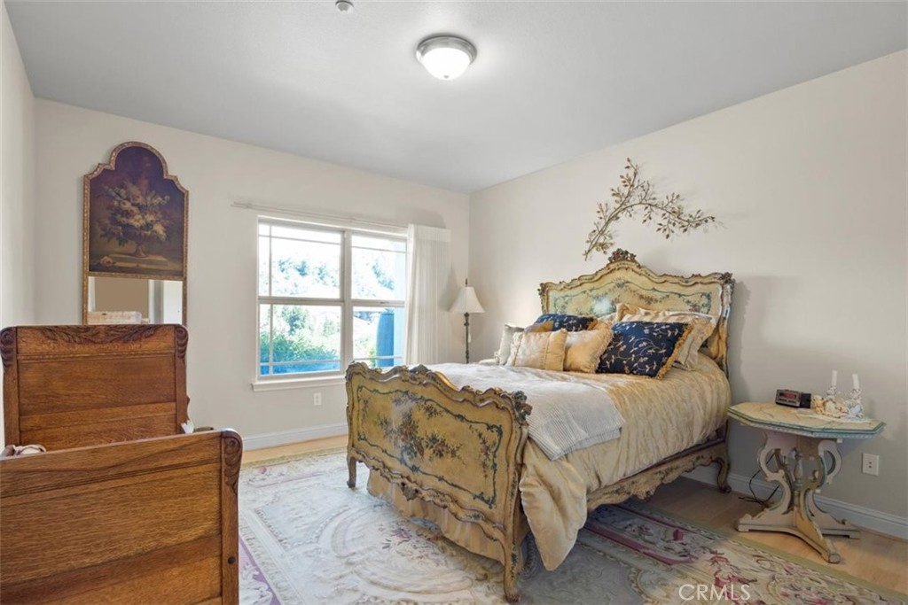 3217 Shallow Springs Terrace Chico, CA 95928 - Photo 39 of 55 a bedroom with a bed and wooden floor