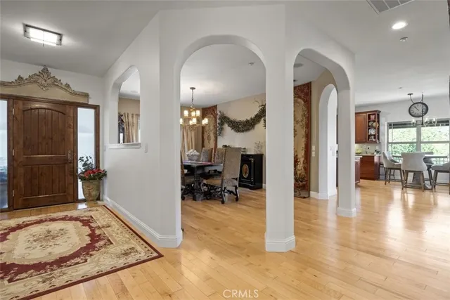 a kitchen with stainless steel appliances granite countertop a stove a sink dishwasher and a dining table with chairs