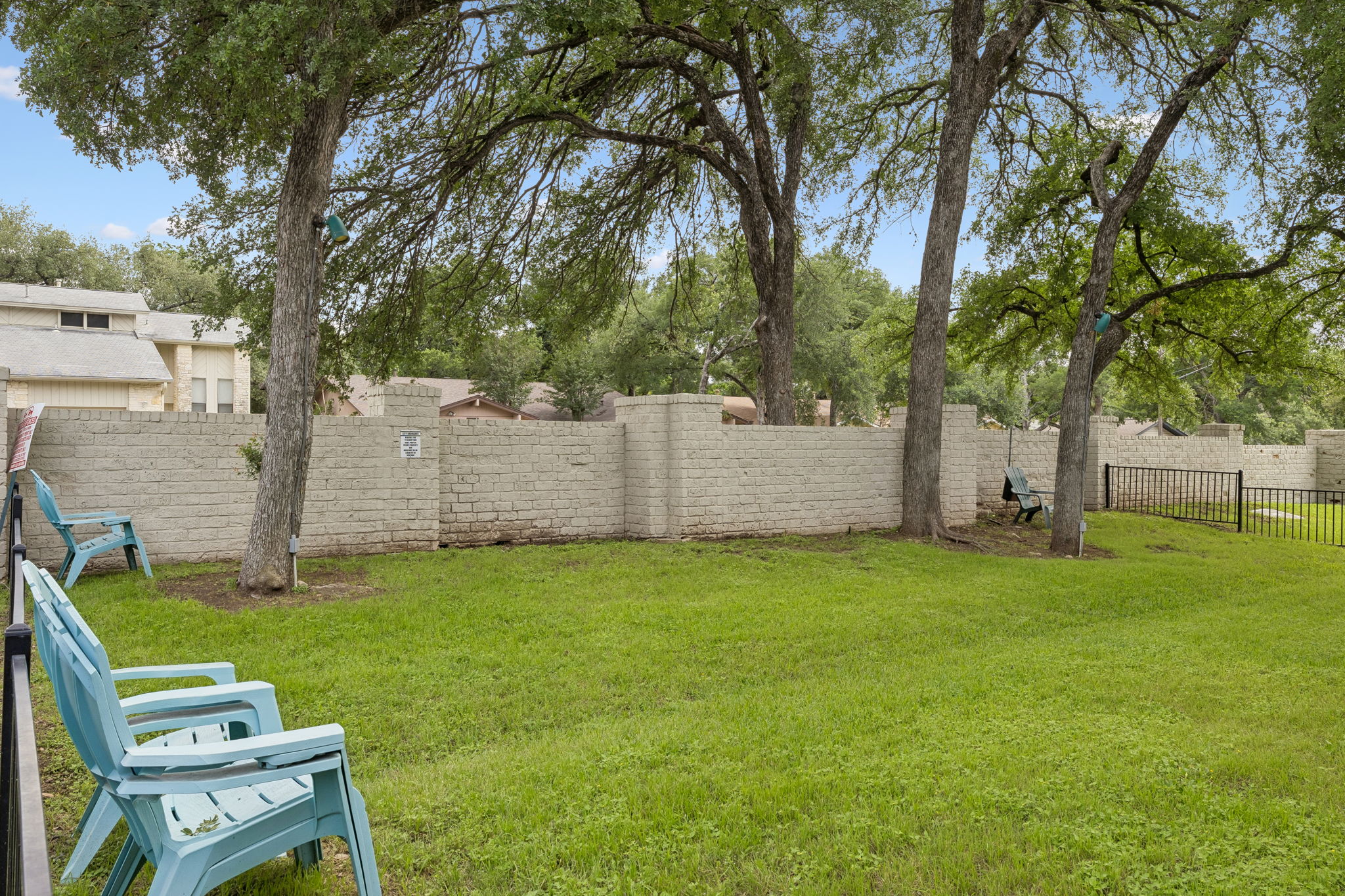 8340 Fathom Circle, Unit 103 Austin, TX 78750 - Photo 30 of 30 a backyard of a house with seating and a garden