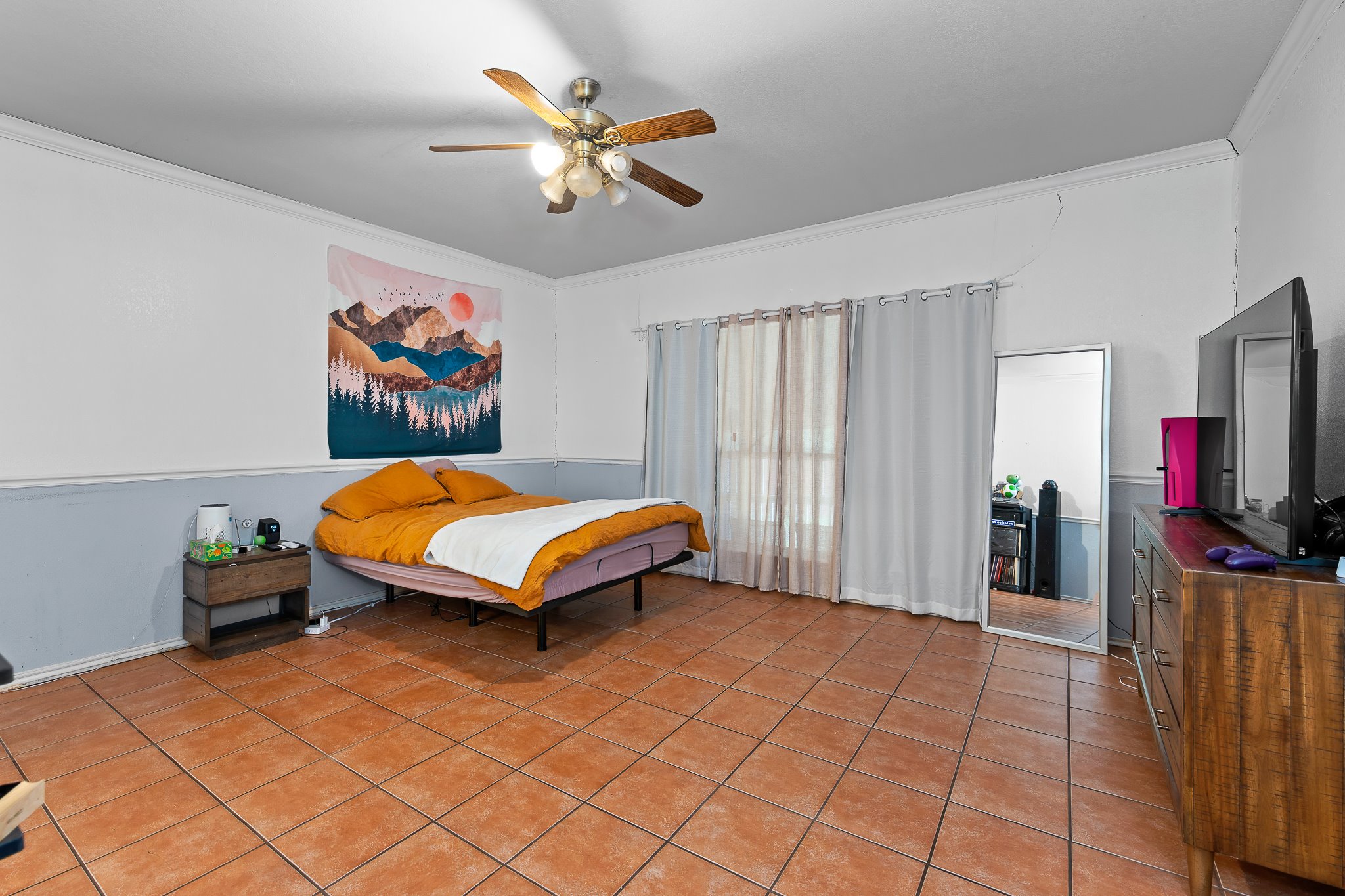 11737 Rydalwater Lane Austin, TX 78754 - Photo 16 of 40 Spacious room featuring tile flooring, a multi-speed ceiling fan with integrated lighting, and crown molding