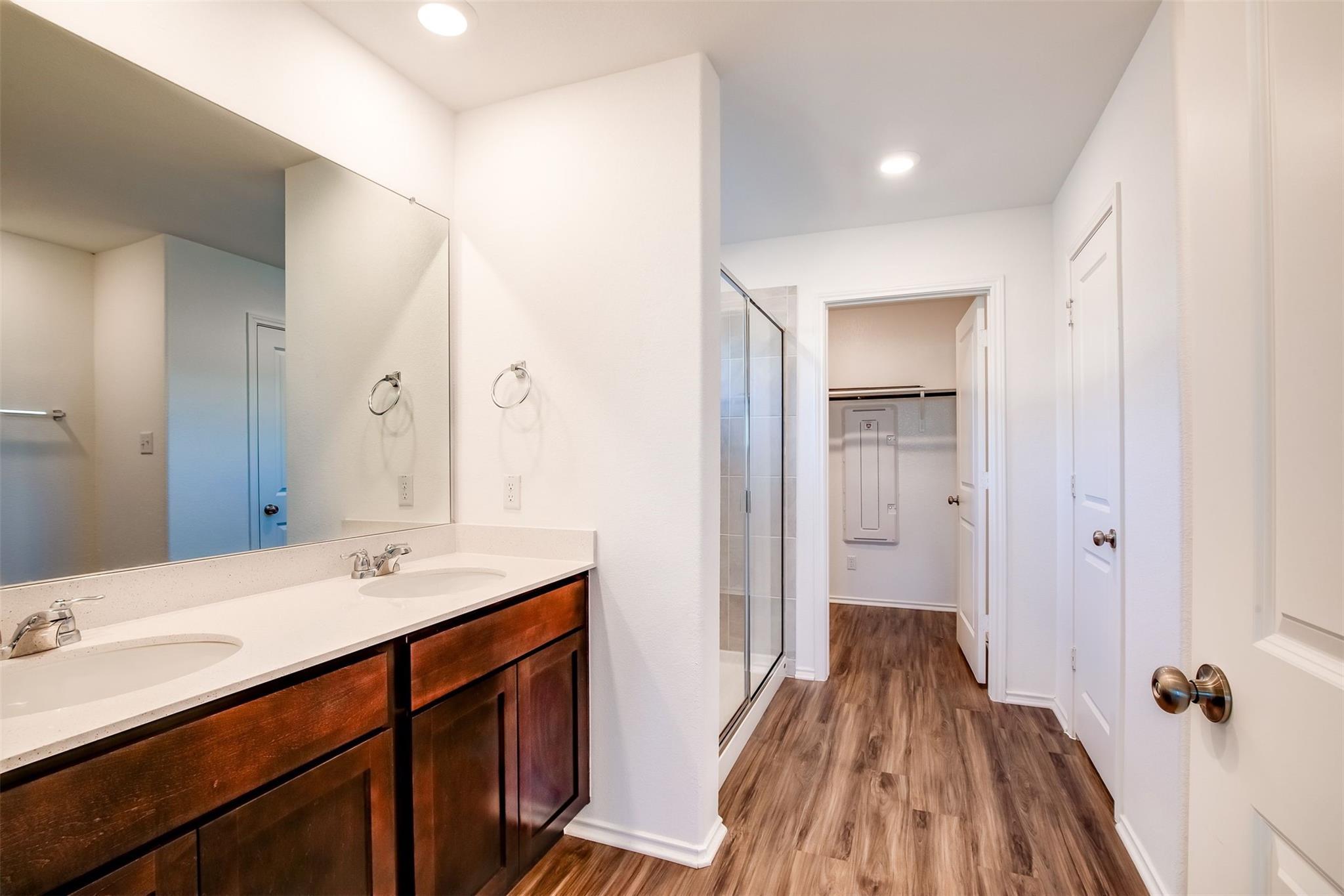 614 Milliner Loop Hutto, TX 78634 - Photo 12 of 25 Double vanity and a spacious shower create a highly functional primary bathroom.