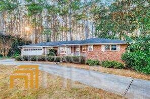 a view of a house with a yard and potted plants