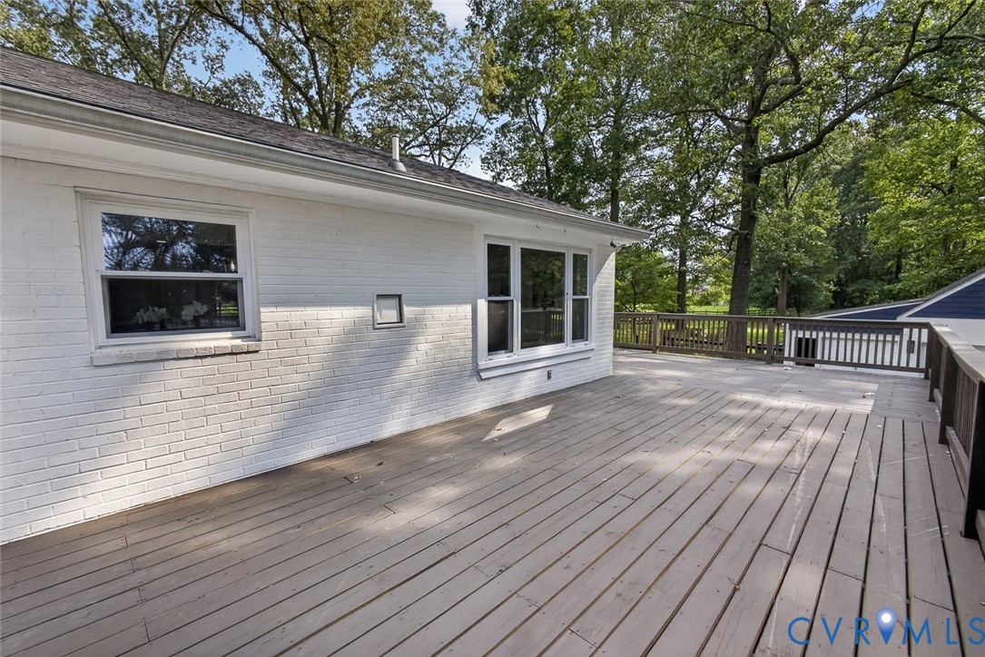 6581 Rural Point Road Mechanicsville, VA 23116 - Photo 41 of 58 Expansive wood deck with wood railings, white bric
