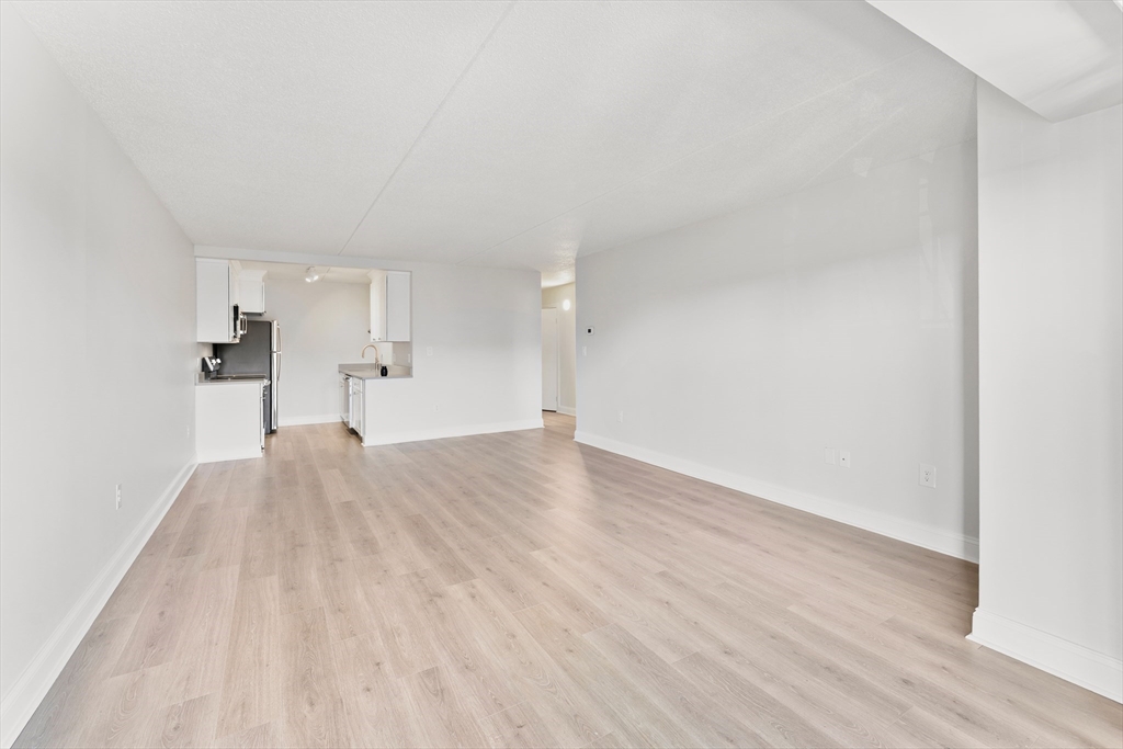 275 Main Street, Unit 404 Watertown, MA 02472 - Photo 18 of 39 a view of empty room with wooden floor