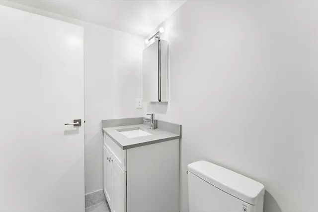 a bathroom with a sink toilet a mirror and shower