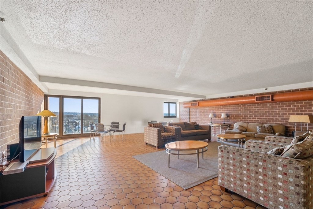 275 Main Street, Unit 404 Watertown, MA 02472 - Photo 32 of 39 a living room with furniture and a flat screen tv
