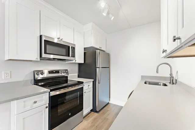 a kitchen with a refrigerator and cabinets