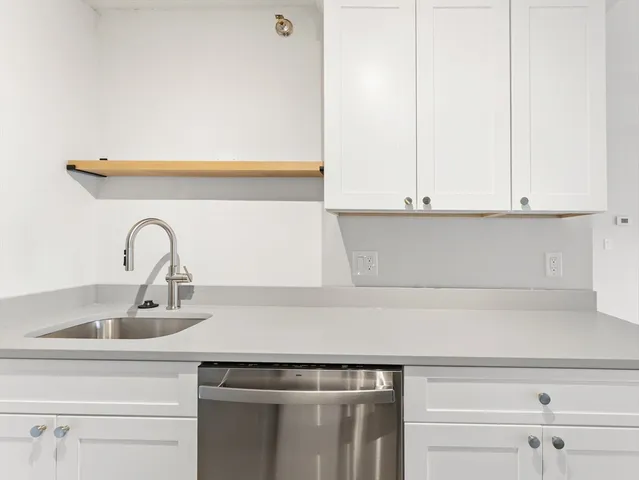 a kitchen with stainless steel appliances white cabinets and a stove