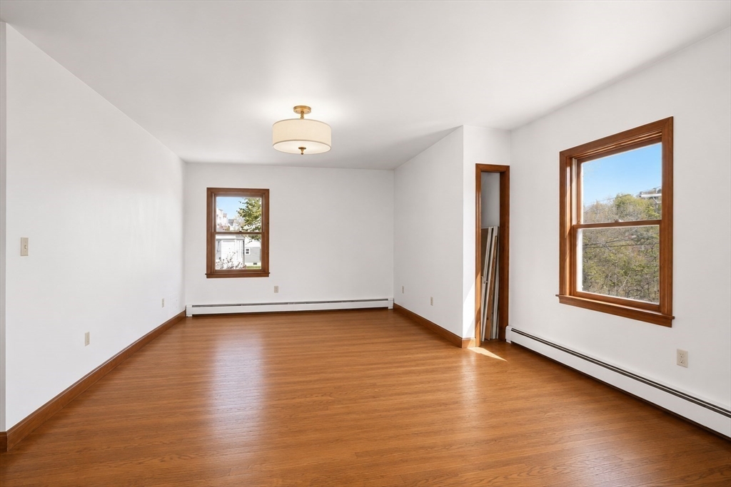 67 Wituwamat Road Weymouth, MA 02191 - Photo 26 of 42 a view of an empty room with a window and wooden floor