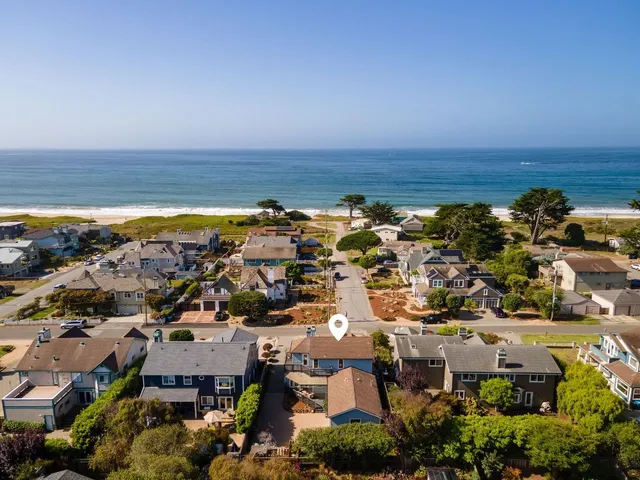 an aerial view of a ocean and city