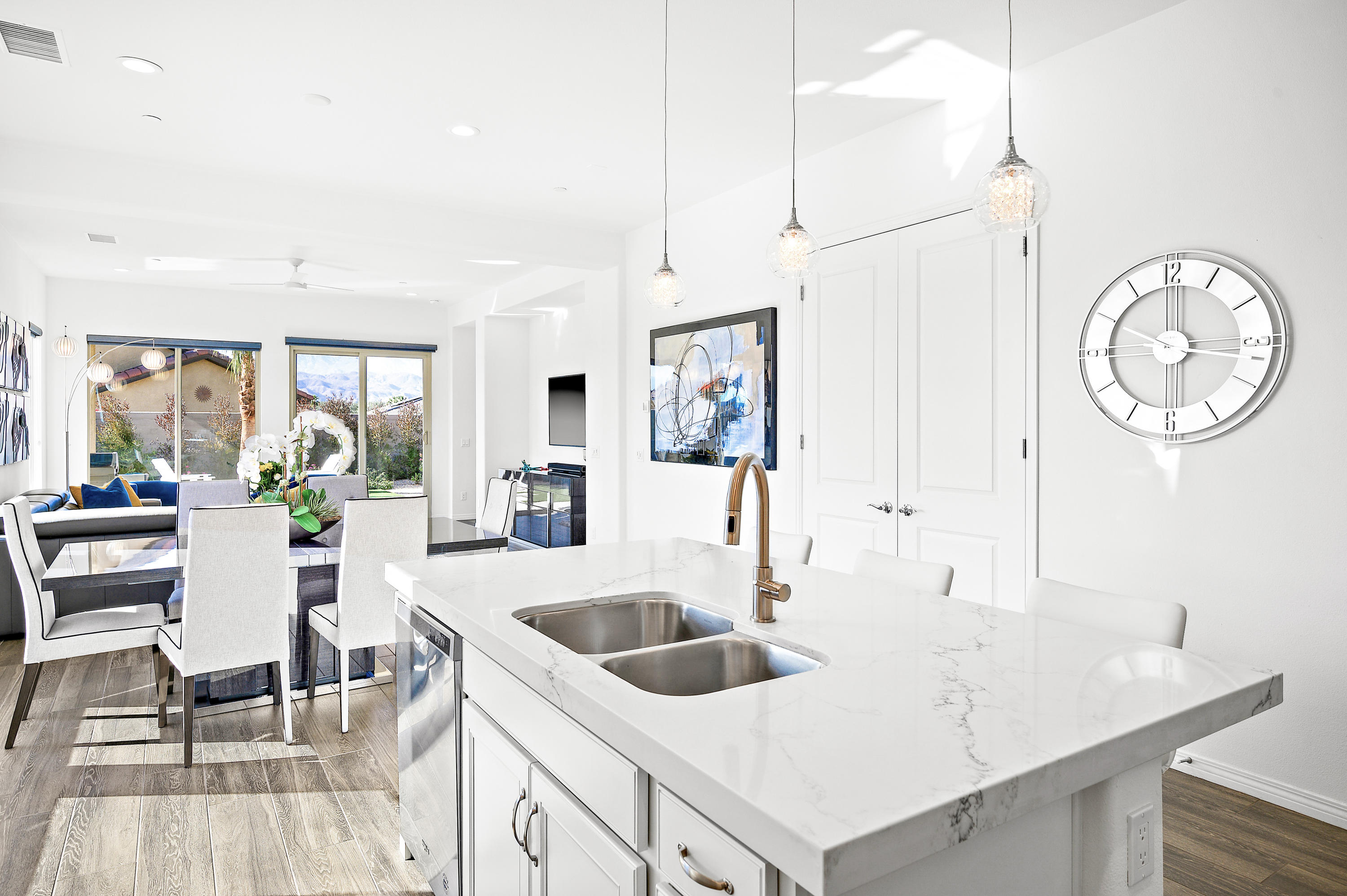 23 Tempranillo Rancho Mirage, CA 92270 - Photo 22 of 51 a kitchen with a table chairs and a clock