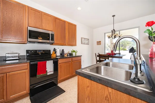 a kitchen with a sink cabinets and stainless steel appliances