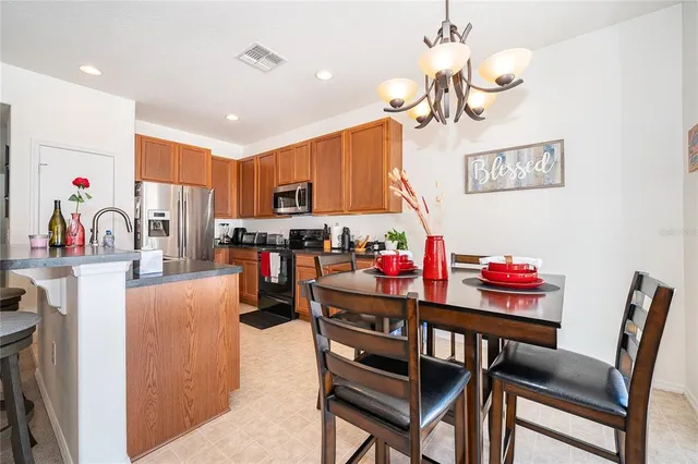 a dining room filled with furniture and a chandelier