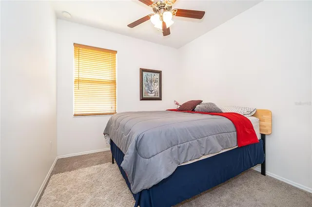 a spacious bedroom with a bed and a window