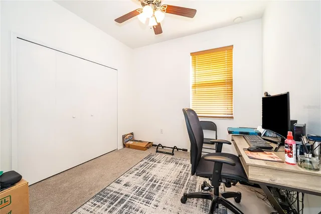 a view of a workspace with furniture and a window