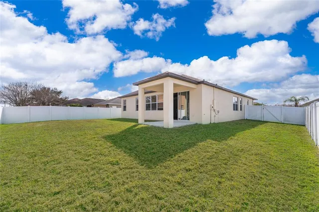 a view of a house with a backyard