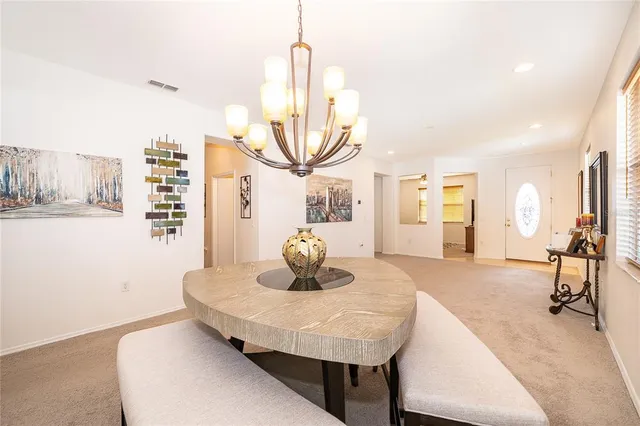 a living room with furniture a flat screen tv and a table