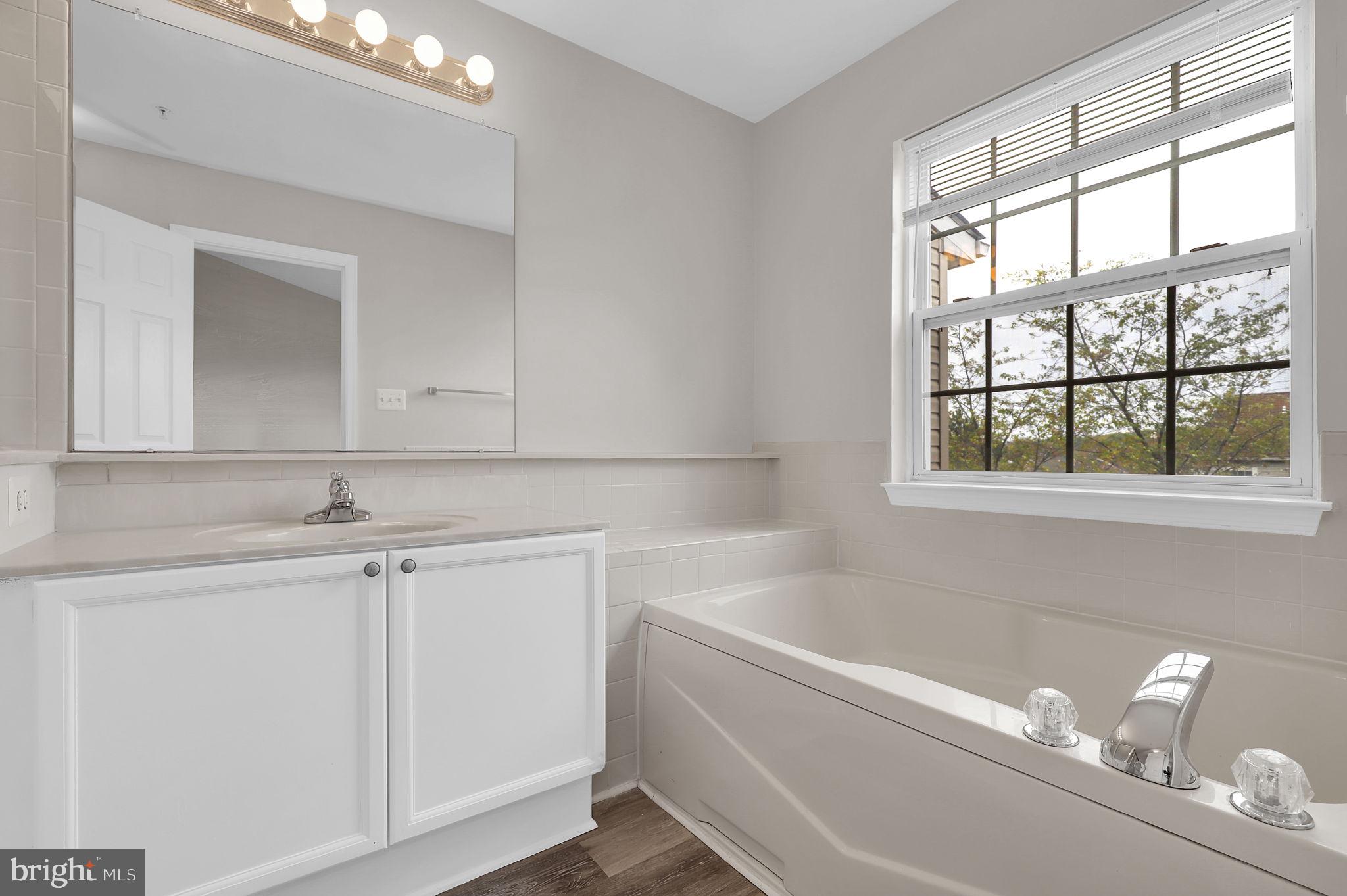 2475 Lakeside Drive Frederick, MD 21702 - Photo 15 of 40 a bathroom with a bathtub and a sink