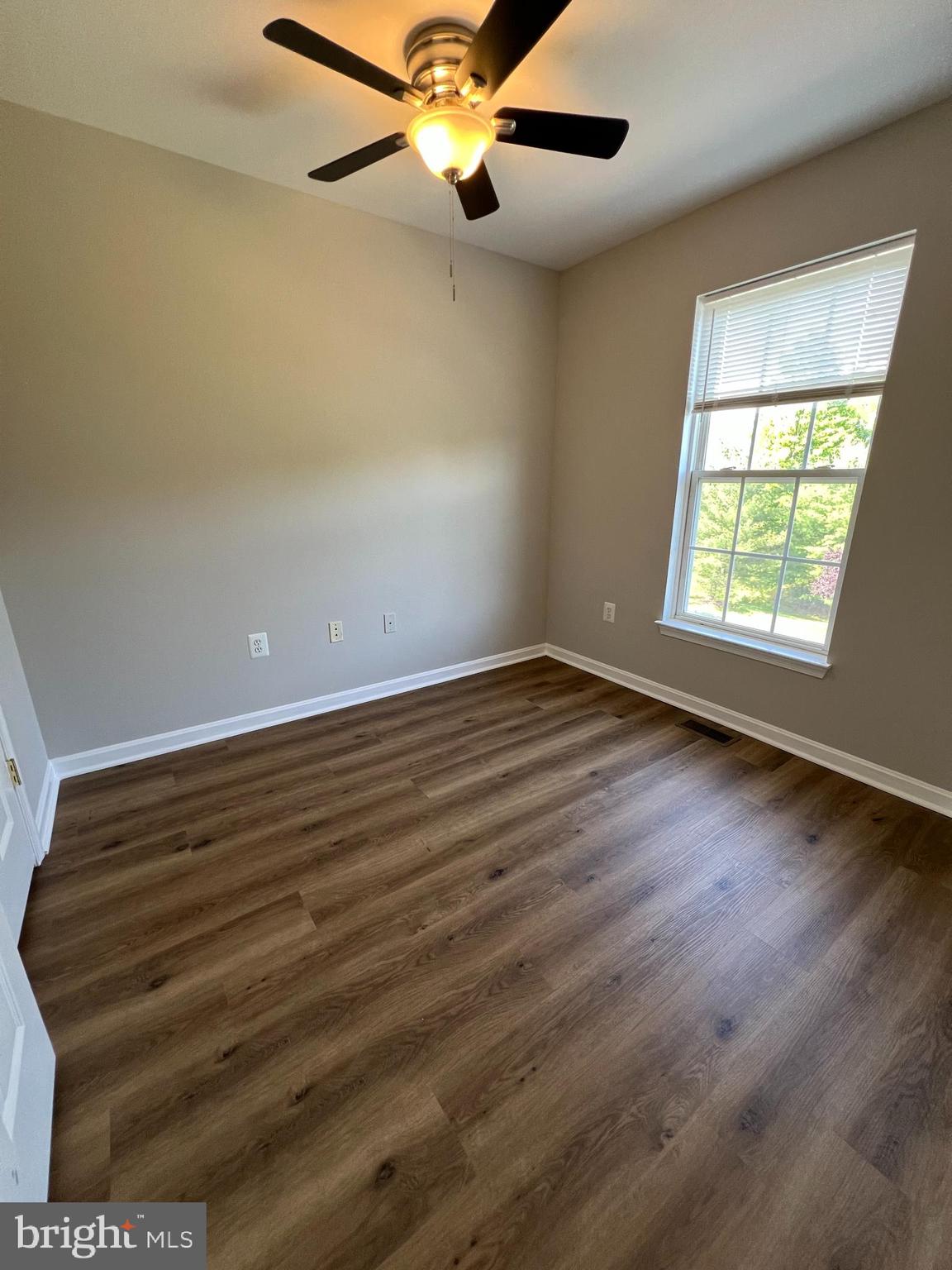2475 Lakeside Drive Frederick, MD 21702 - Photo 30 of 40 an empty room with wooden floor fan and windows