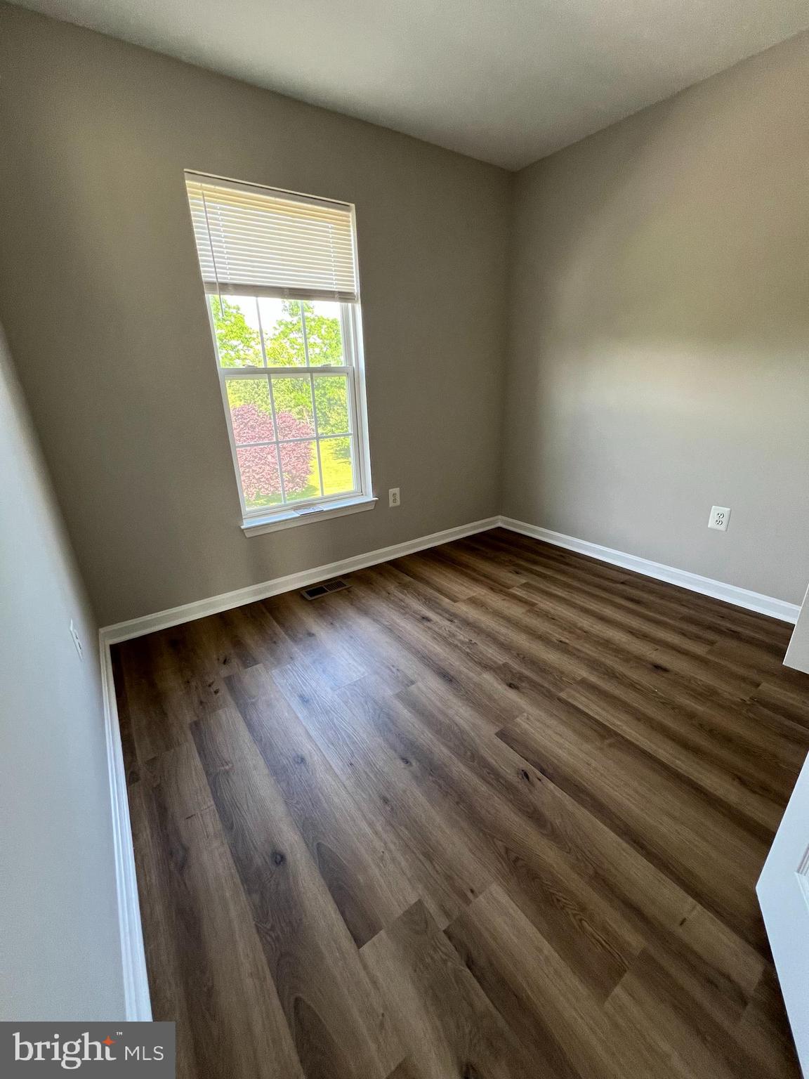 2475 Lakeside Drive Frederick, MD 21702 - Photo 31 of 40 an empty room with wooden floor and windows