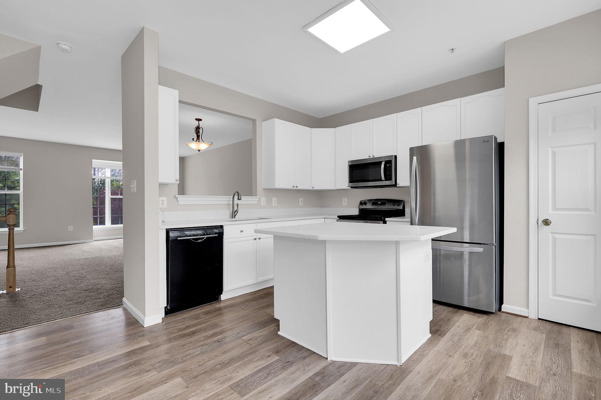 2475 Lakeside Drive Frederick, MD 21702 - Photo 4 of 40 a kitchen with a refrigerator stove and wooden floor