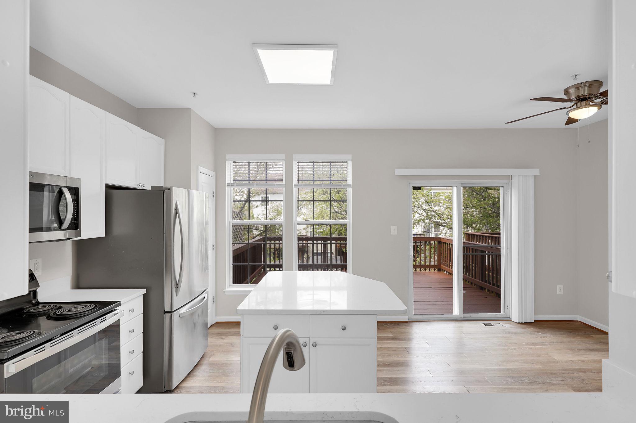 2475 Lakeside Drive Frederick, MD 21702 - Photo 7 of 40 a kitchen with stainless steel appliances kitchen island granite countertop a refrigerator a stove and a sink with granite countertops