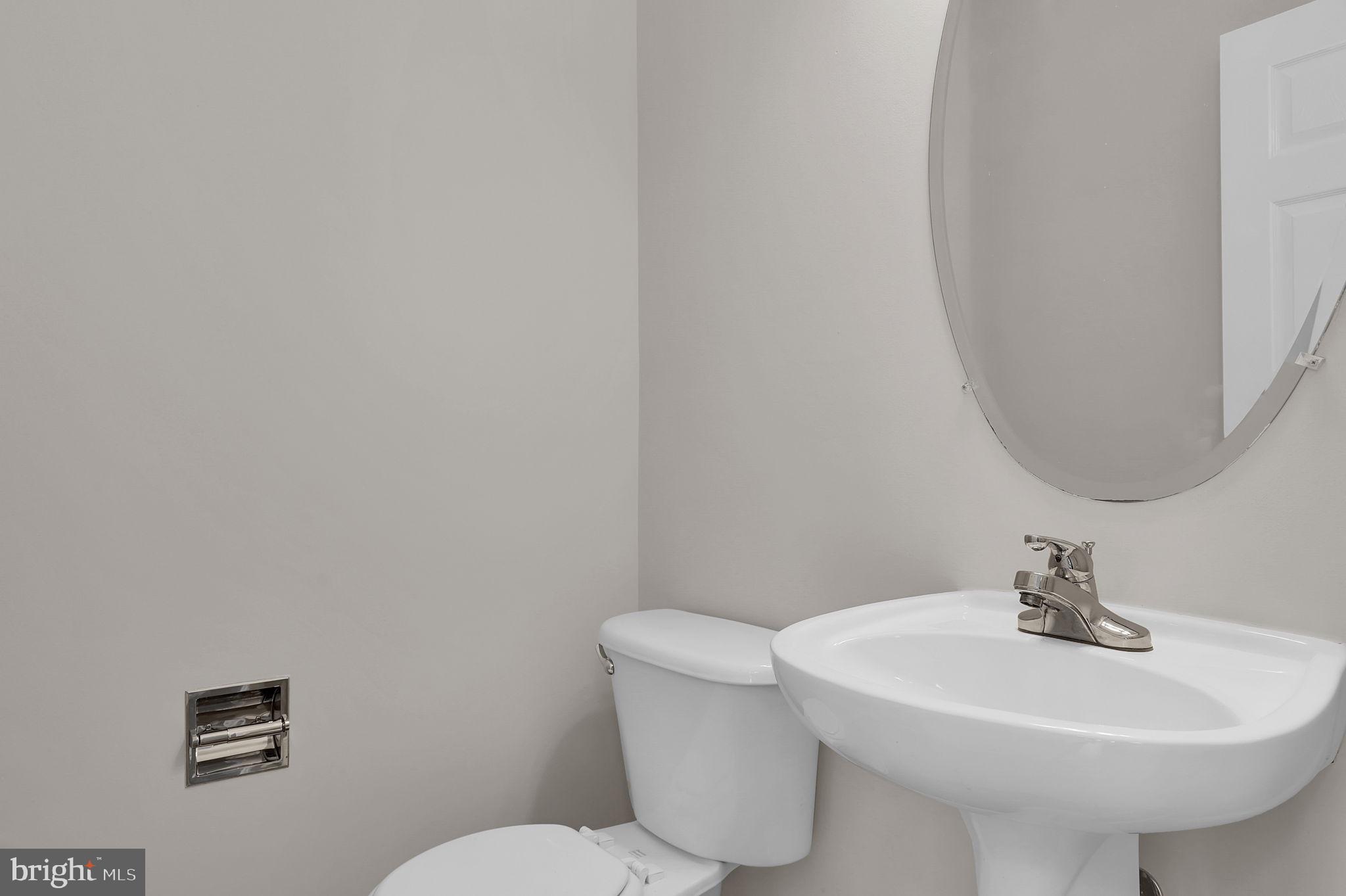 2475 Lakeside Drive Frederick, MD 21702 - Photo 10 of 40 a bathroom with a sink a toilet and mirror