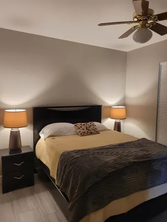 a bedroom with a bed and lamps