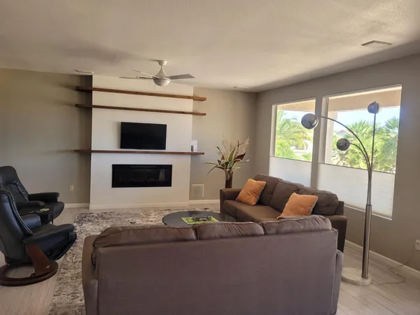 a living room with furniture a fireplace and a flat screen tv