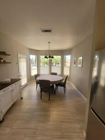 a dining room with furniture and window