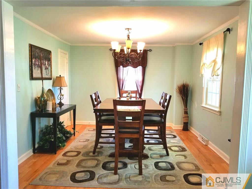 68 3rd Street Edison, NJ 08837 - Photo 4 of 13 a view of a dining room with furniture and wooden floor