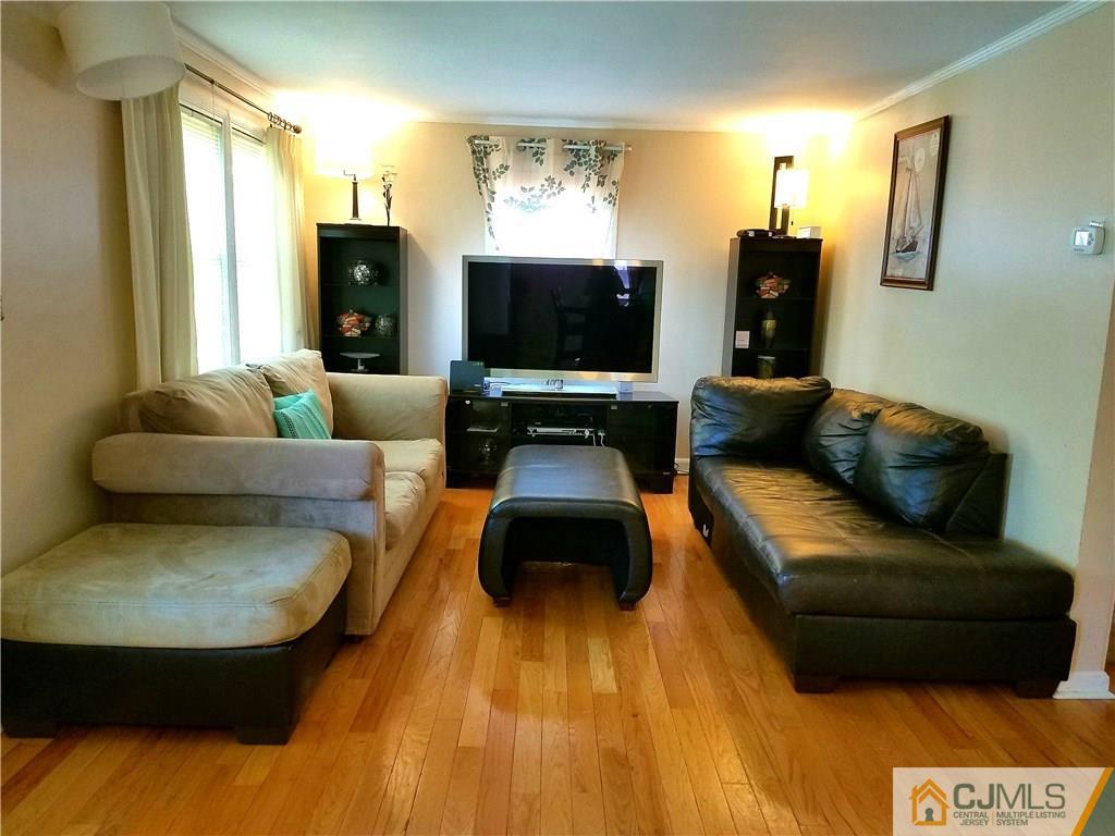 68 3rd Street Edison, NJ 08837 - Photo 6 of 13 a living room with furniture and a flat screen tv