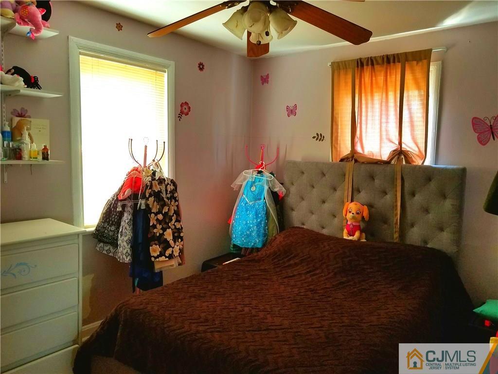 68 3rd Street Edison, NJ 08837 - Photo 8 of 13 a bedroom with a bed and a window