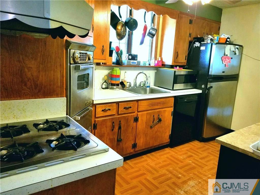 68 3rd Street Edison, NJ 08837 - Photo 10 of 13 a kitchen with stainless steel appliances granite countertop a stove and a sink