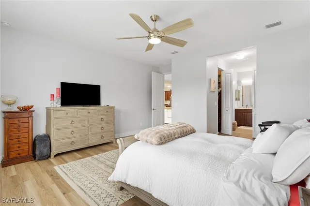 a bedroom with furniture tv and a window