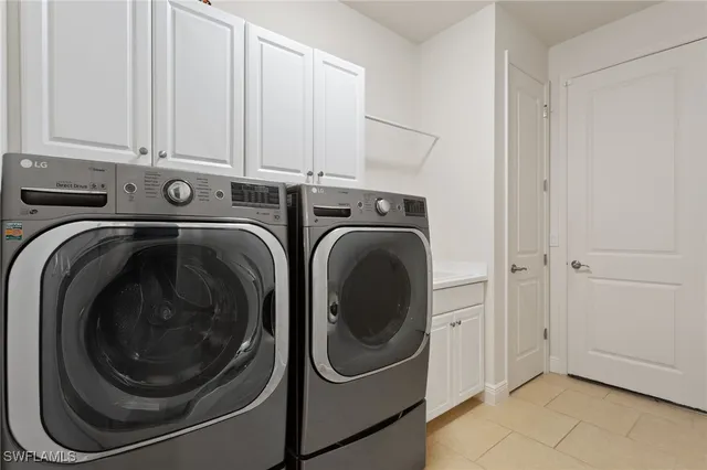 a living room with furniture and floor to ceiling windows