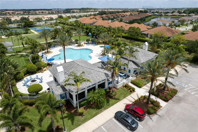 an aerial view of residential houses with outdoor space and swimming pool