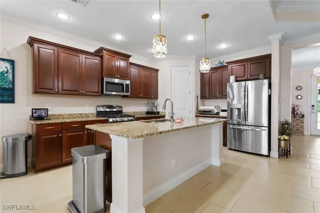 a kitchen with stainless steel appliances granite countertop a stove refrigerator sink and microwave