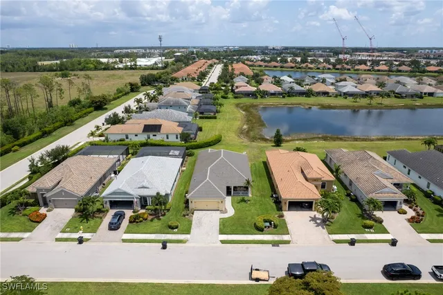 an aerial view of a house with swimming pool and green space