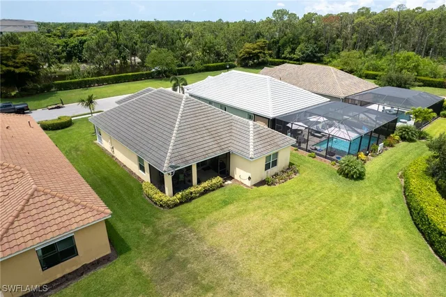 an aerial view of a residential houses with outdoor space and street view