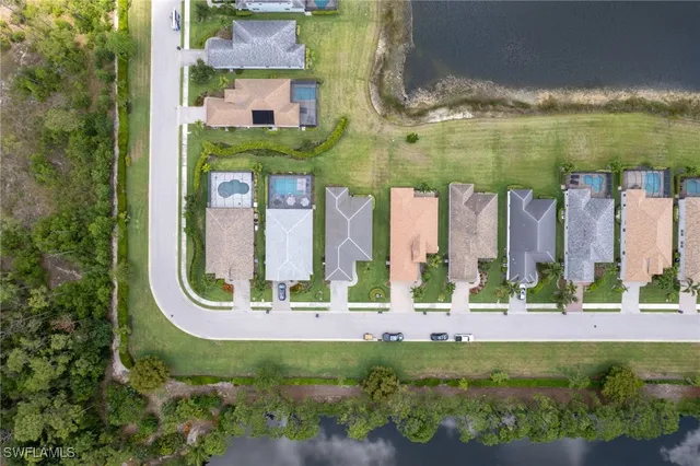 an aerial view of residential building and lake