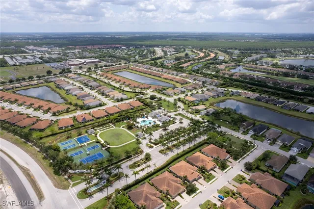 a front view of a house with a garden and yard